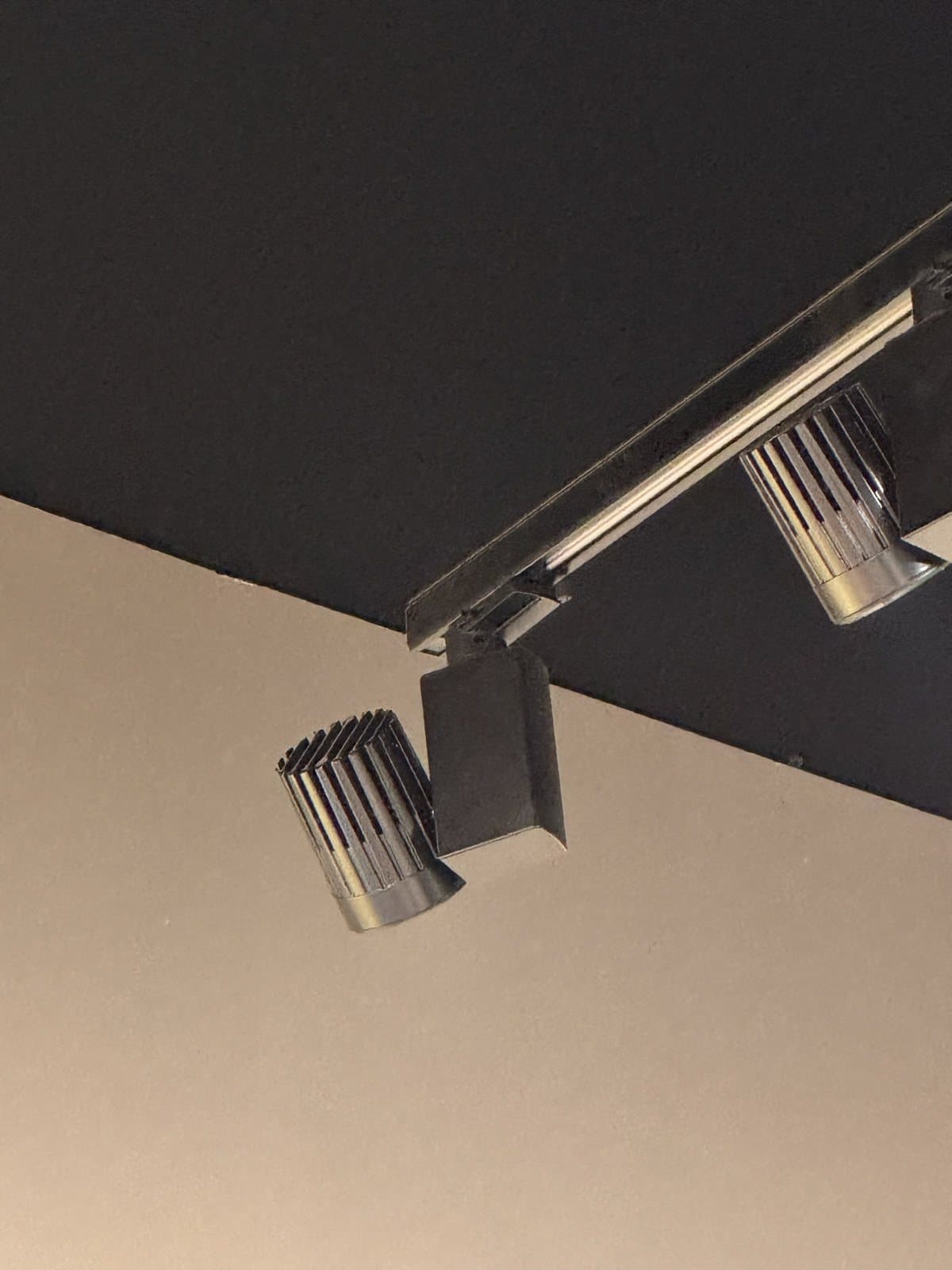 A reclaimed track spotlight installed on a JLL ceiling track