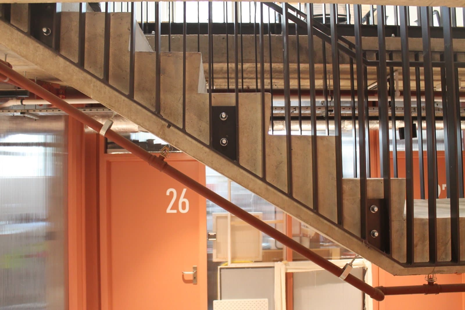 The steel staircase at Lisson Arches over the orange studio doors