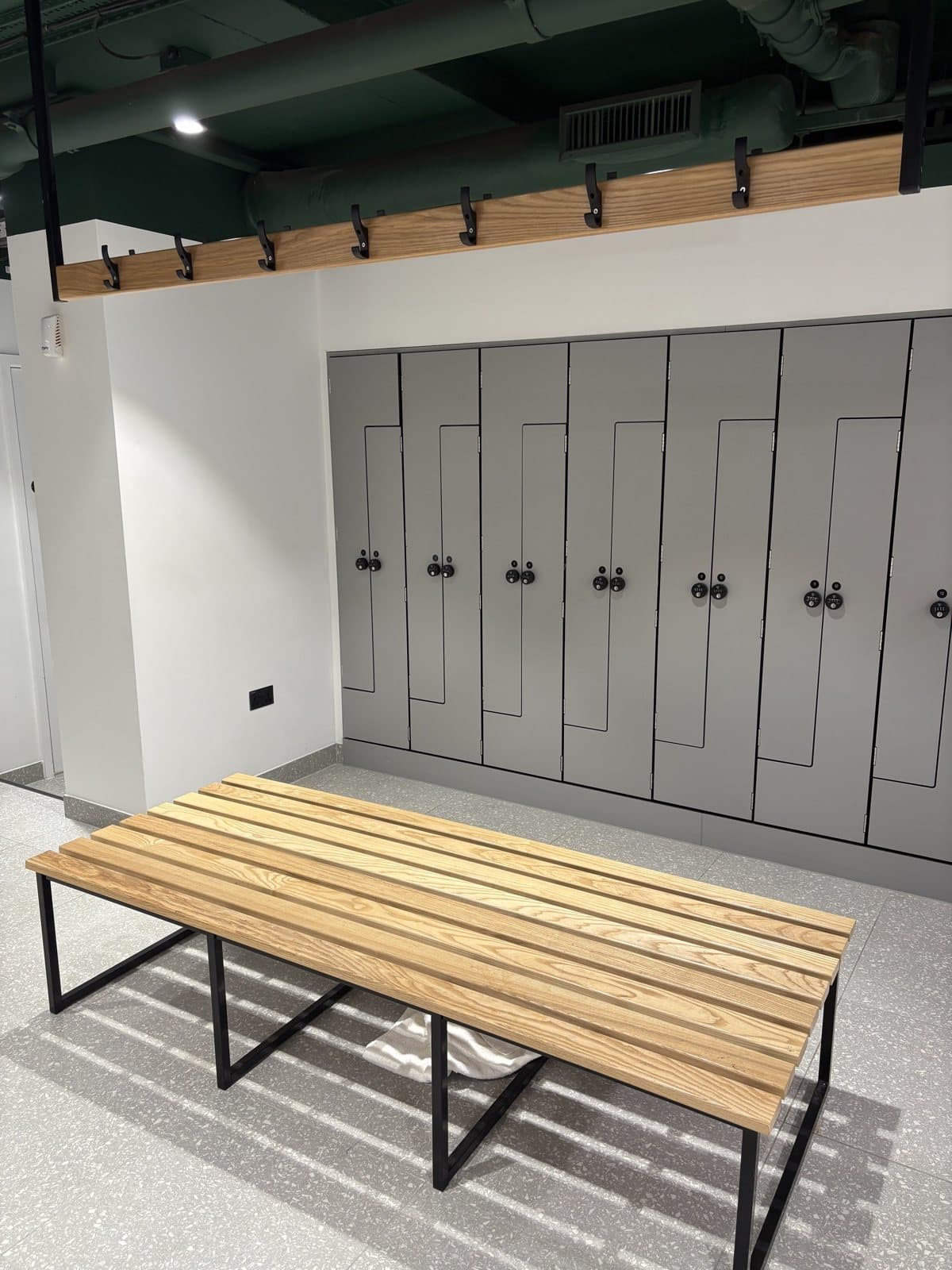 Changing room lockers and a timber bench at Peninsular House