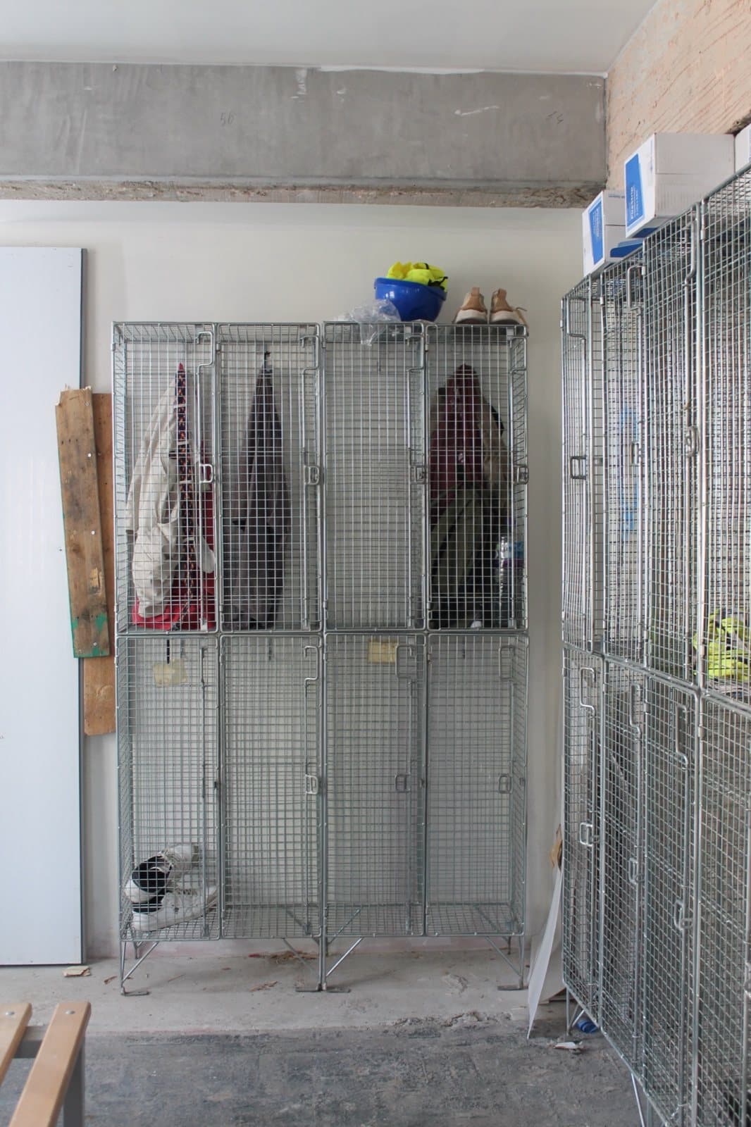 Two banks of reclaimed wire mesh lockers in the Virtus site welfare room