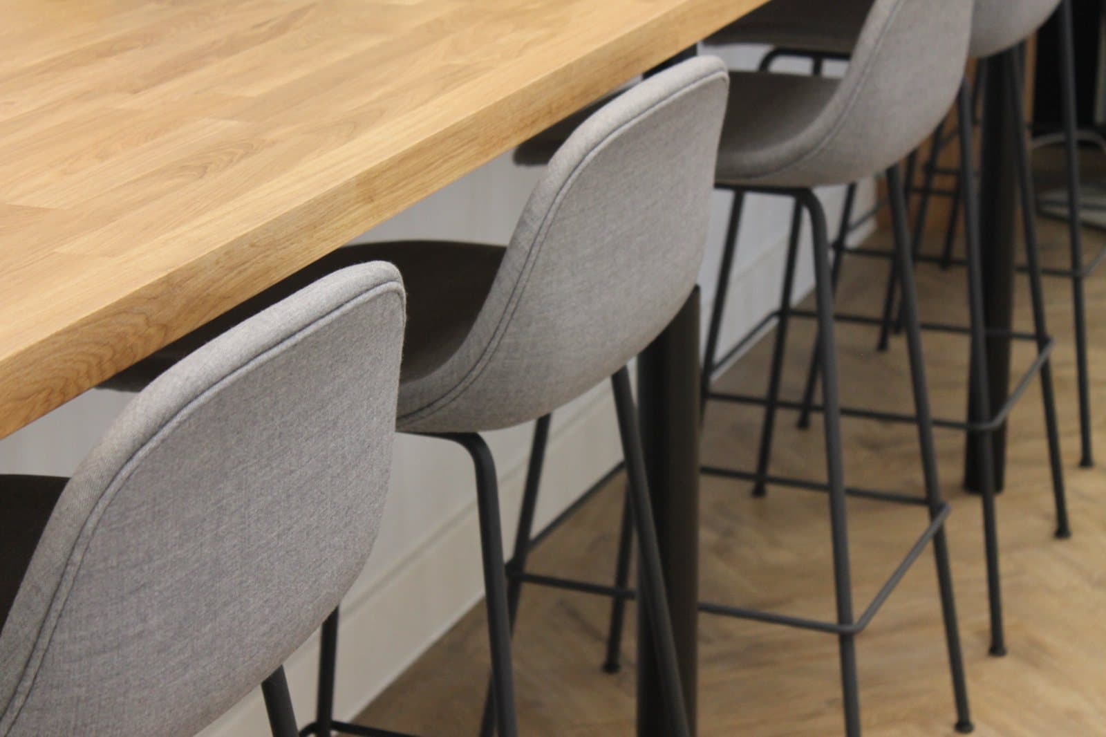 Reclaimed bar stools along the counter at Wates SES, Portsoken House