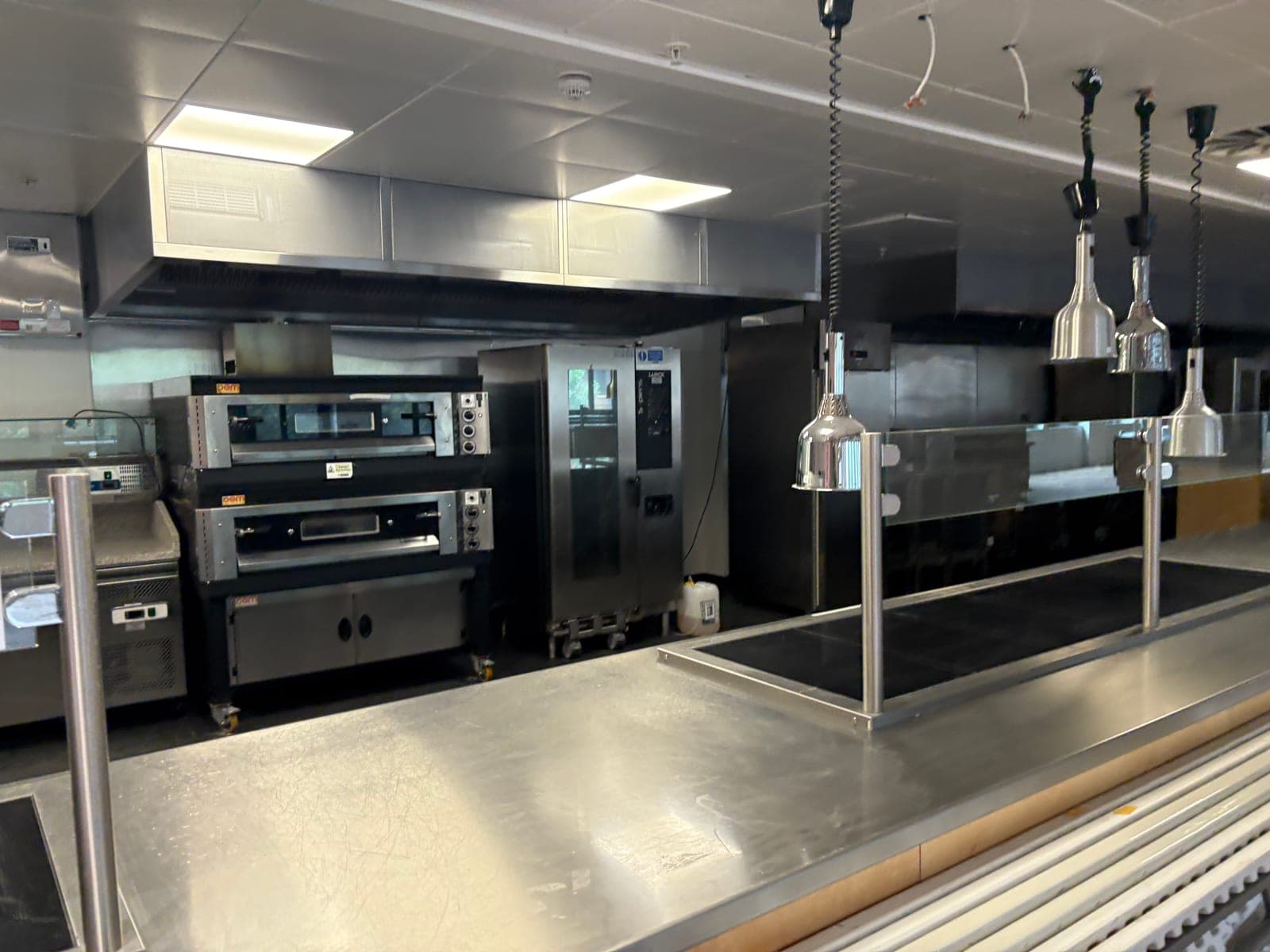 Commercial kitchen with ovens, a combi oven and a heated servery