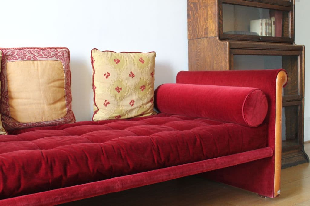 Red velvet upholstered sofa