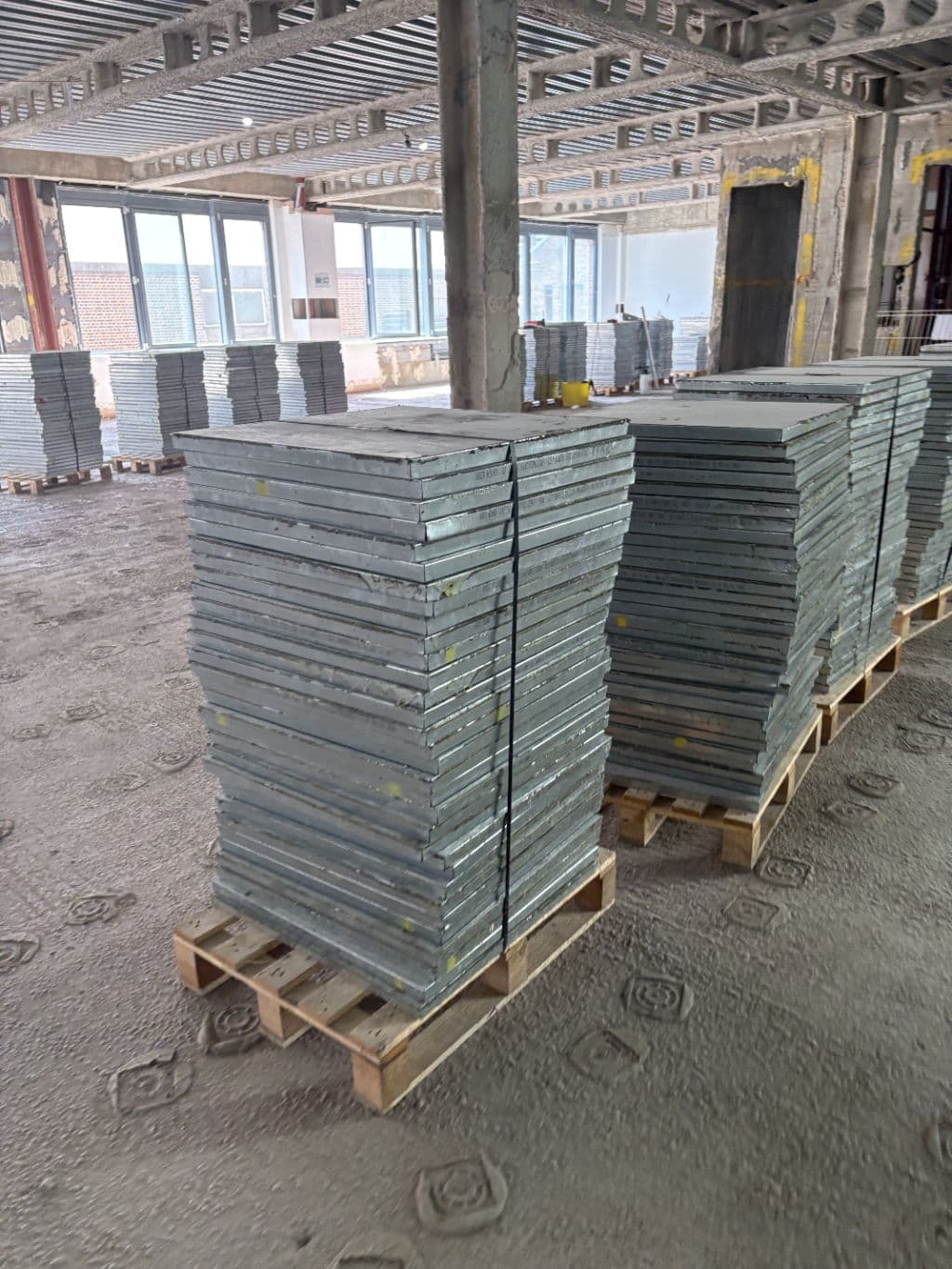 Steel raised access floor panels stacked for collection